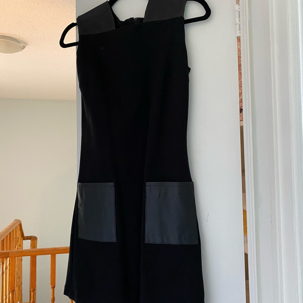 Black dress with leather pocket and shoulder detail